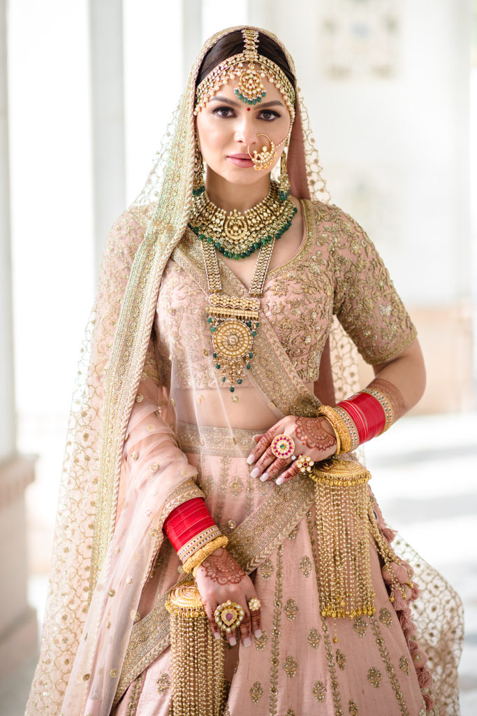 Bride Dee wearing Sabyasachi powder pink dress