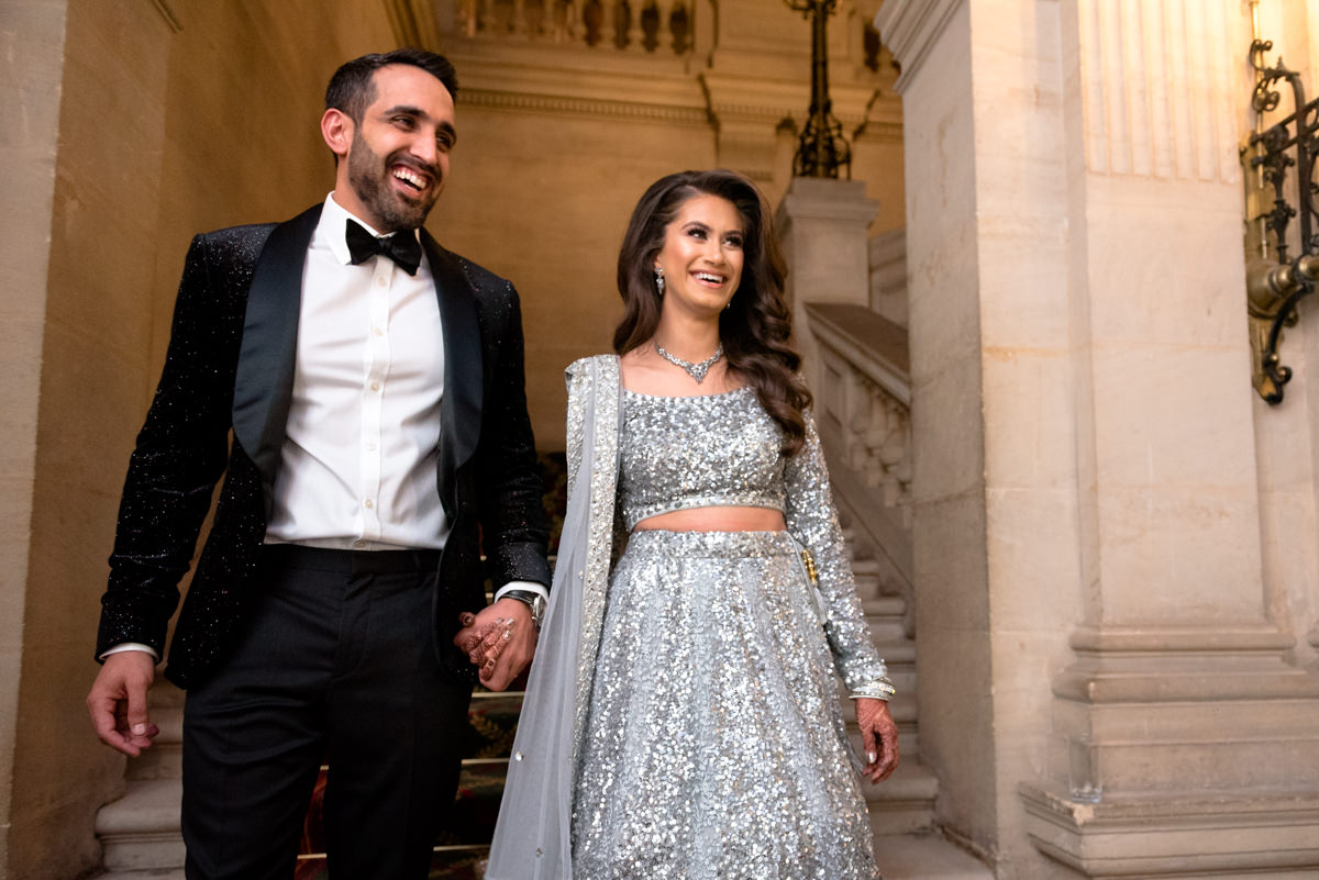 Asian couple entering their wedding reception 